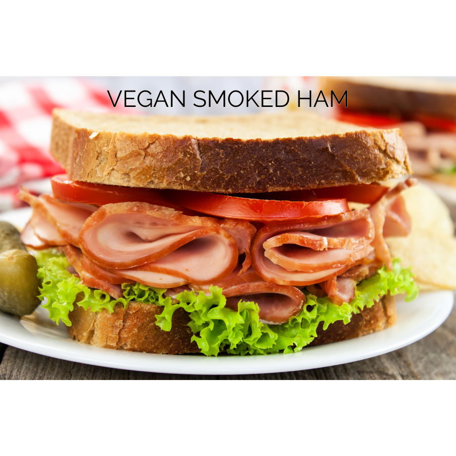 Vegan sandwich featuring Prime Roots Deli Meats - Smoked Turkey layered with greens and tomatoes for a hearty meal.