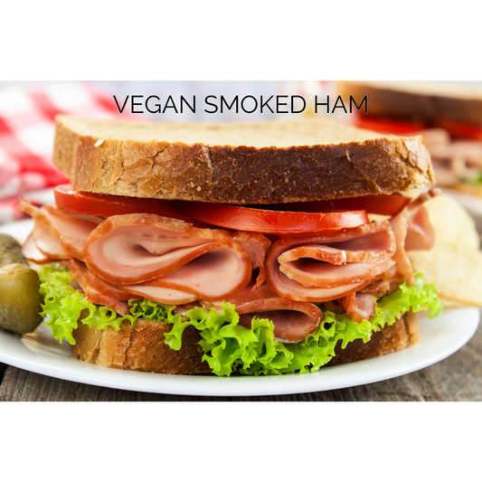 Vegan sandwich featuring Prime Roots Deli Meats - Smoked Turkey layered with greens and tomatoes for a hearty meal.